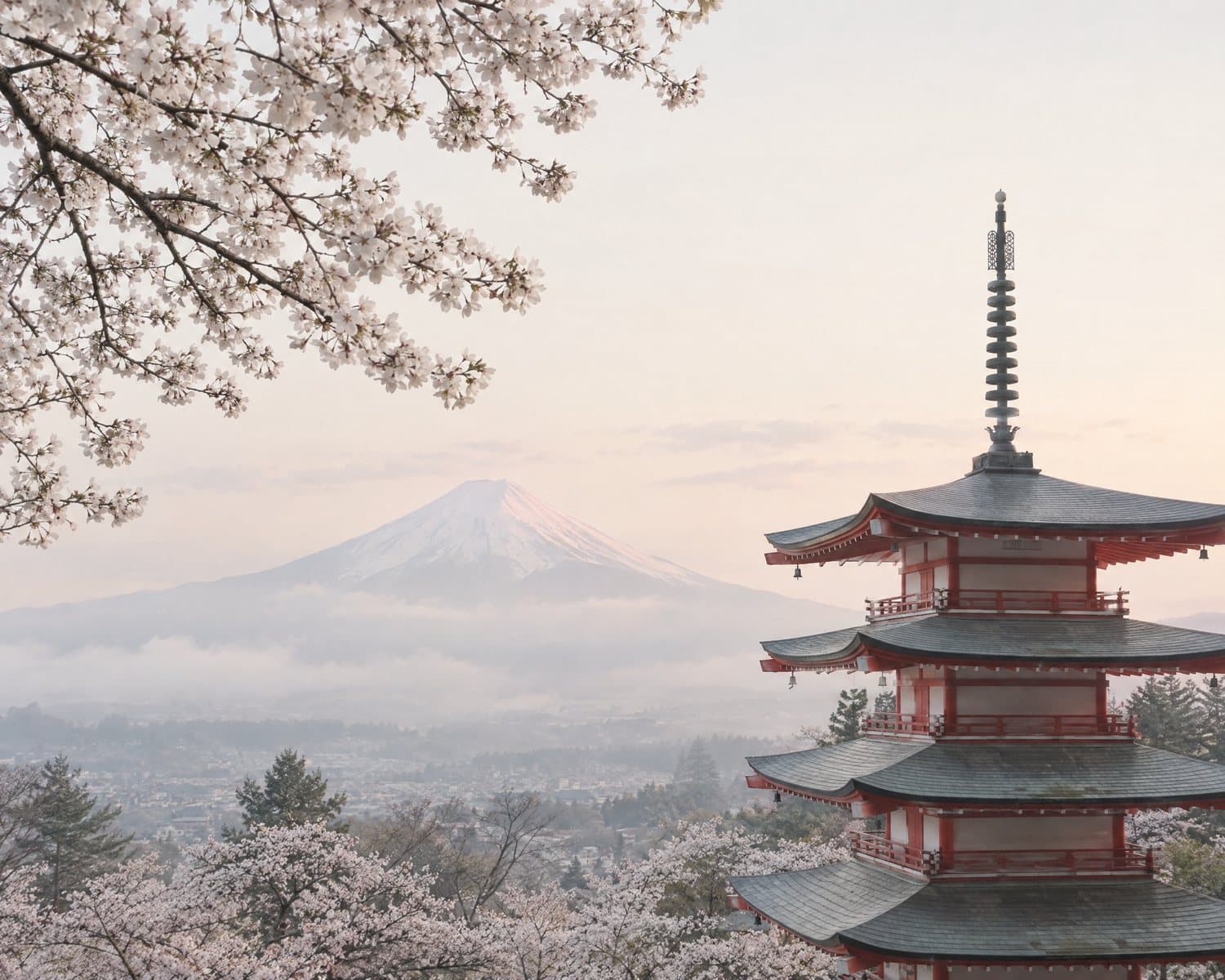 A pagoda and Mount Fuji under a gold evening sky